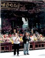 Young girls light incense at the Lungshan temple, Taipei